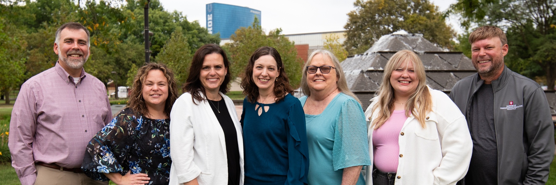 Picture of the seven members of the STEM cluster standing in front of Wood fountain on a fall day.