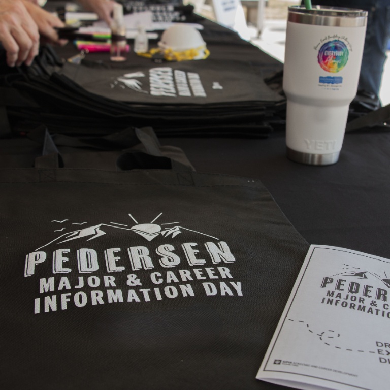 Image of a PMCID tote bag lying on a table